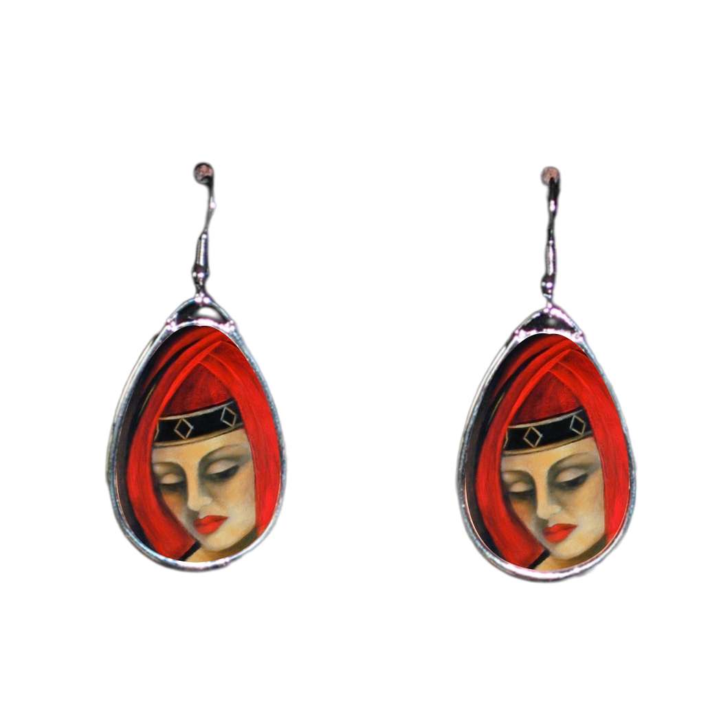 Teardrop-shaped earrings with a face design on a white background