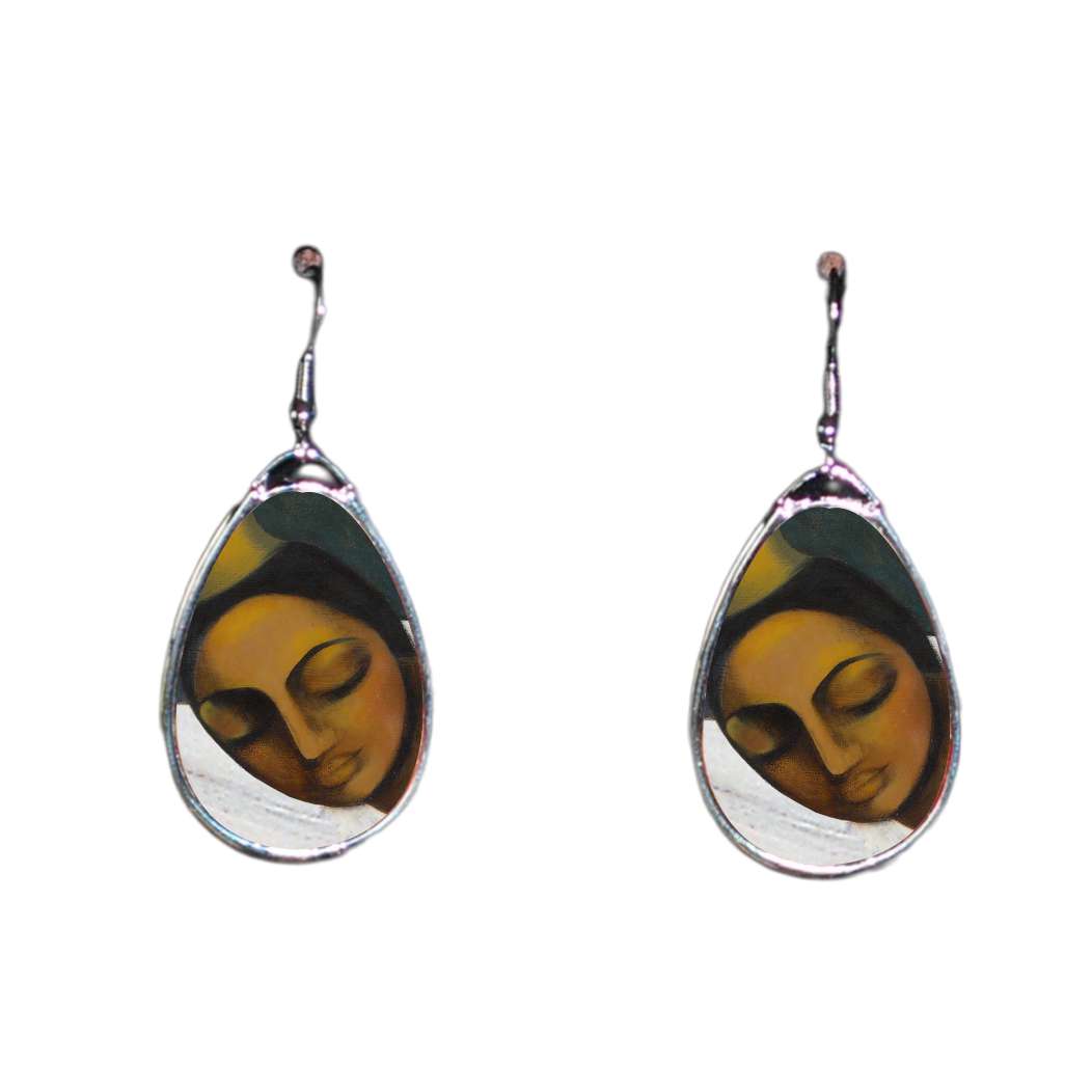Teardrop-shaped earrings with a face design on a white background