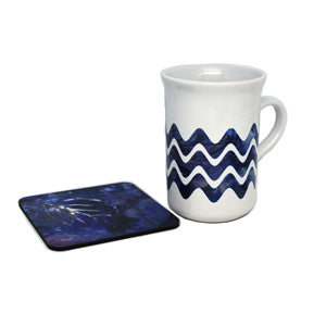 Beach decor accessories. A blue cup and coaster.