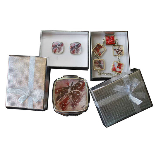 Set of decorative items including a compact mirror, earrings, and bracelet in gift boxes on a white background.
