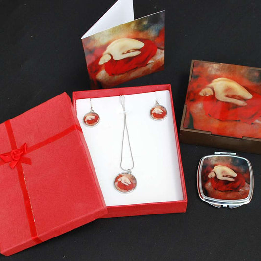 Jewelry set with necklace, earrings, and compact mirror in a red box on a black background.