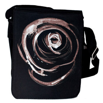Black sling bag featuring a large circular abstract rose in grey, beige, and white on the front, with a black shoulder strap visible on the right side.